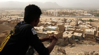 A Yemeni sits on a mountain overlooking the mud-brick 'skyscrapers' of the ancient walled city of Shibam in Hadramout province, Yemen, 12 July, 2018. EPA