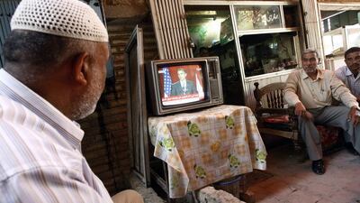 Men watch a live broadcast of a speech delivered in Cairo by US president Barrack Obama, in Baghdad in 2009. Ahmed Al Rubaye / AFP