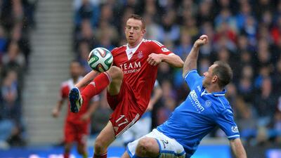 Frazer Wright of St Johnstone and Adam Rooney of Aberdeen challenge during the William Hill Scottish Cup Semi Final between St Johnstone and Aberdeen at Ibrox Stadium on April 13, 2014 in Glasgow, Scotland. Mark Runnacles/Getty Images