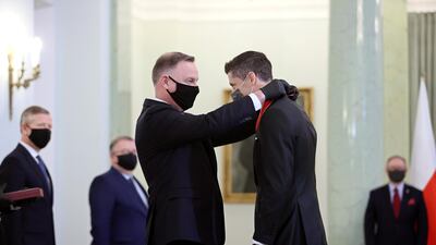 Robert Lewandowski receives the Commander's Cross of the Order of Polonia Restituta from Polish President Andrzej Duda at the Presidential Palace in Warsaw. EPA
