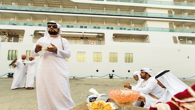 Emirati men wait to greet passengers disembarking from the Seabourn Encore. Christopher Pike / The National