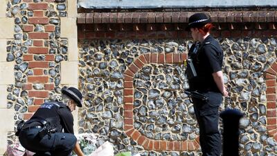 A police officer lays flowers near to the scene of reported multiple stabbings in Reading, Britain, June 22, 2020. REUTERS/Peter Nicholls
