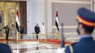 Sheikh Mohamed bin Zayed, Crown Prince of Abu Dhabi and Deputy Supreme Commander of the Armed Forces, and Abdel Fattah El Sisi, President of Egypt, stand for the national anthem during a reception at the Presidential Airport. Hamad Al Kaabi / Crown Prince Court - Abu Dhabi