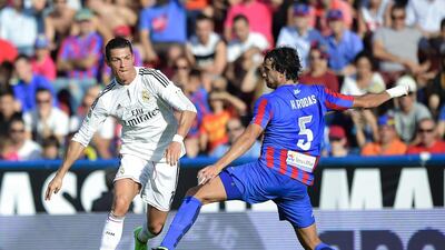 Real Madrid's Cristiano Ronaldo, left, vies with Levante Hector Rodas during their Spanish Primera Liga match at the Ciutat de Valencia stadium in Valencia on October 18, 2014. Jose Jordan / AFP