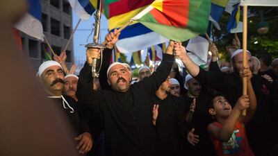 Israelis of the Druze minority during a demonstration in the northern Israeli Druze town of Daliyat Al Carmel on June 14, 2015, calling for the Israeli government to support and help their relatives in embattled Syria. Syrians on their way to an Israeli hospital were attacked on Tuesday by Druze who are traditional allies of Syrian president Bashar al Assad. Menahem Kahana/AFP Photo