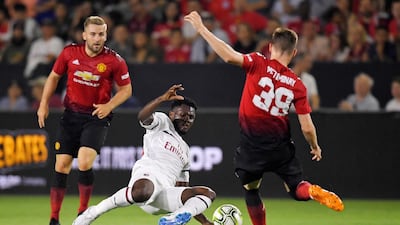 AC Milan's Franck Kessie tackles Manchester United's Scott McTominay. AP Photo