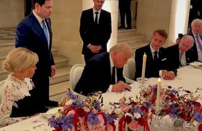 Jean-Noel Barrot, in background, watches US President Donald Trump sign the Iran deal. AFP