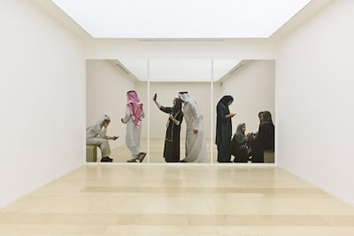Michelangelo Pistoletto’s ‘Perzone in Communicazione’ (2019) is a mirror that also has images of people on it, as seen above, who appear to be reflections. Ahmed Al Thani