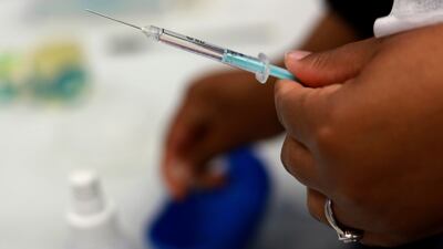 A Johnson & Johnson booster vaccine is prepared at the Vaccination Centre of Hope at the Cape Town International Convention Centre in Cape Town. AP