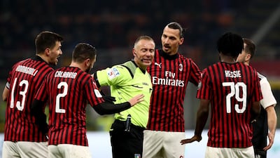 Zlatan Ibrahimovic and his AC Milan teammates argue with Paolo Valeri after the referee awarded Juve's late penalty. AFP