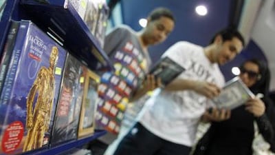 A family looks at a Michael Jackson CD at a Manama music store that the singer visited in 2006.