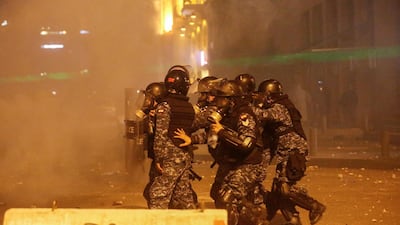 Riot police walk together during a protest in Beirut, Lebanon. Reuters