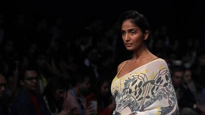 Bahl also presented a range of saris with multicoloured patchwork against creamy white fabrics. EPA