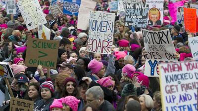 Women with pink hats and signs begin to gather in Washington, DC on January 21, 2017 as part of a day of worldwide protests against the policies of the new US president Donald Trump. Jose Luis Magana / AP Photo