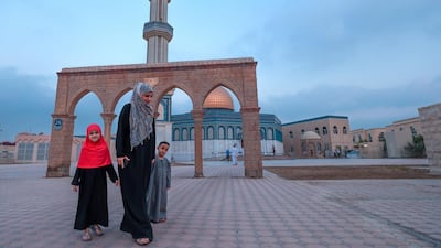 Asma Al Bayouk take her children, Hmymn and Yassin, to the Women's prayer room with her for Eid prayers. Victor Besa/The National