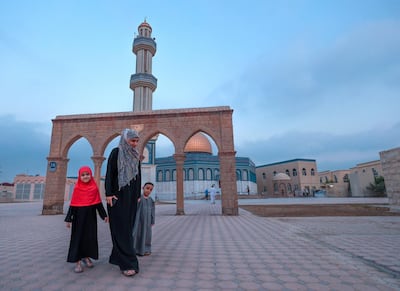 Asma Al Bayouk take her children, Hmymn and Yassin, to the Women's prayer room with her for Eid prayers. Victor Besa/The National