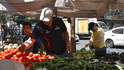 Syrians shop for vegetables at a market in Damascus on Sunday July 11, hours after Syrian President Bashar Al Assad issued a legislative decree granting civil servants and military members a 50 per cent pay rise. The decision comes a day after the government raised the price of fuel by more than 50 per cent for the third time this year. EPA