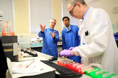 Britain's Chancellor of the Exchequer Rishi Sunak is shown the testing of samples for respiratory viruses at Leeds General Infirmary in Yorkshire. AFP