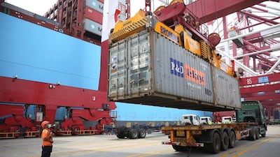 A container is loaded on to a ship at Qingdao's port in China. The country's debt is on track to hit 335 per cent of GDP, according to a new report. AP