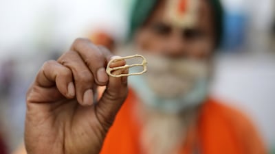 An Indian monk applies tilak to devotees during Makar Sankranti on Sagar Island, about 130km south of Kolkata. EPA