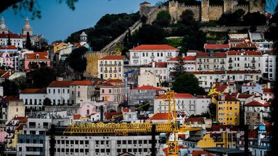 A construction crane rises in downtown Lisbon. Today the city today is a hive of activity as the property market recovers. Patricia De Melo Moreira/AFP
