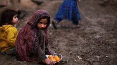 A child sells oranges in an alley of a poor Rawalpindi neighbourhood. Food prices are high and the economy is in recession.