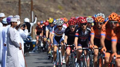 The peloton rides past spectators on Friday during the fourth and final stage of the Tour of Oman. Eric Feferberg / AFP