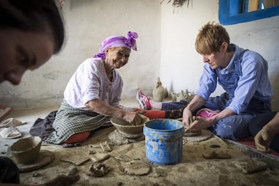 Aicha Tabiz teaches an apprentice at one of her pottery workshops. AFP