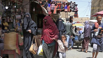 Yemeni women walk past shops in the old city market of the capital Sanaa. AFP