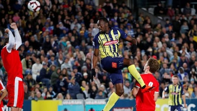 Usain Bolt heads the ball during a pre-season friendly for Central Coast Mariners. AFP