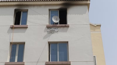 Signs of smoke damage around the windows of a third story apartment in the England Cluster of International City where a fire claimed the lives of two men after they jumped from the balcony. Antonie Robertson / The National