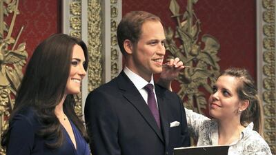 A gallery assistant attends waxwork models of Britain’s Prince William and his wife Catherine, Duchess of Cambridge, at Madame Tussauds in London. Olivia Harris / Reuters