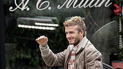 David Beckham gestures towards his fans as he arrives to the AC Milan sports centre, in Carnago, Itlay.