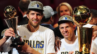 Dirk Nowitzki, left, and Jason Kidd, right. of the Dallas Mavericks hold the MVP and Larry O'Brien Trophies after defeating the Miami Heat in Game 6.