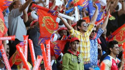 Crowds cheering at Sharjah Cricket Stadium as they watch the Indian Premier League match between Royal Challengers Bangalore vand Delhi Daredevils on April 17, 2014. Labourers in Musaffah's workers' quarters will be gathering for the live matches when they appear on the big screens in their camps. Pawan Singh / The National
