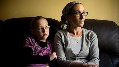 Naama Margolese, 8, sits with her mother, Hadassa, in their home in Beit Shemesh. The town outside Jerusalem has become a symbol of the worsening relations between extremists and Israel’s majority.