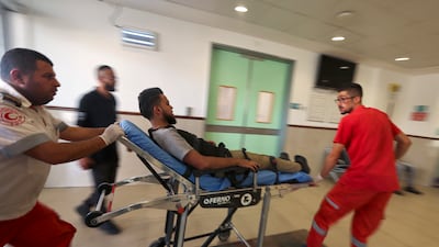 Members of the Palestinian Red Crescent transport an injured man to a hospital in Jenin. AFP