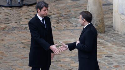 President Macron shakes hands with French Prime Minister Gabriel Attal (left). AFP
