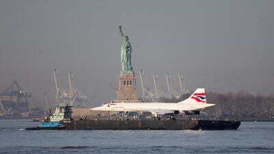 A Concorde supersonic jet is carried on a barge along the Hudson River past the Statue of Liberty, back to the Intrepid Museum in Manhattan after being refurbished at the Brooklyn Navy Yard, in New York City. Reuters