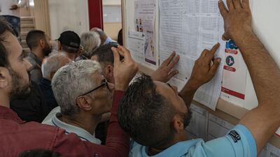 Voters look at a list of candidates at a polling station in Beirut. Bloomberg