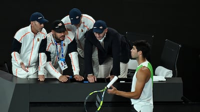 Carlos Alcaraz speaks to his coaching team during the final. EPA