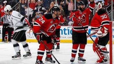 Bryce Salvador, Andy Greene and Martin Brodeur celebrate after defeating the Los Angeles Kings