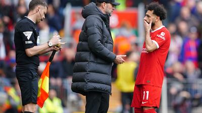 Liverpool manager Jurgen Klopp speaks to Mohamed Salah on the touchline. PA