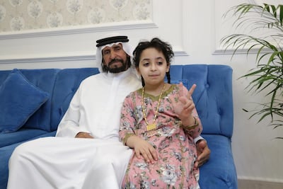 Bakheet Al Mansoori with his daughter at their home in Al Dhafra. Nilanjana Gupta / The National
