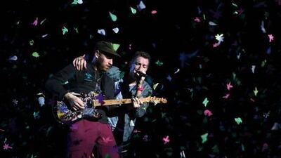 Coldplay's lead guitarist Jonny Buckland, left, and singer Chris Martin usher in the New Year amid a torrent of confetti at their concert in Abu Dhabi.