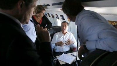 Republican presidential nominee Mitt Romney talks to his senior advisers while on his campaign plane en route to Denver, Colorado earlier this month.
