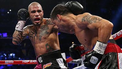Miguel Cotto glances a left punch off the head of Sergio Martinez during the third round of the WBC Middleweight Championship fight at Madison Square Garden in New York City. Cotto won by a TKO in the ninth round. Rich Schultz / Getty Images