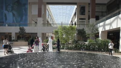Shoppers walk through Yas Mall’s Town Centre on its opening day on Yas Island yesterday. Silvia Razgova / The National