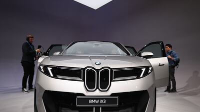 People look at the New Class BMW iX3 vehicle during its World premiere in Munich, Germany, 05 September 2025. The International Motor Show Germany IAA MOBILITY 2025 takes place in Munich from 09 to 14 September 2025, featuring numerous world premieres, and focuses on electric mobility and digitization. EPA / ANNA SZILAGYI