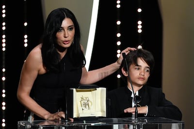 Lebanese director Nadine Labaki delivers a speech on stage next to Syrian actor Zain al-Rafeea. AFP